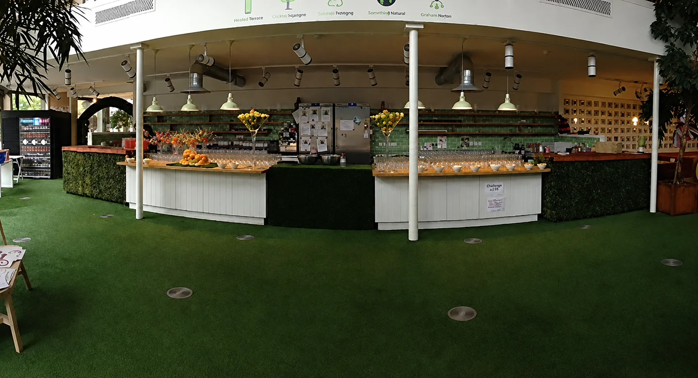 Large covered festival bar with guests and service counters