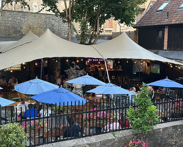 Open-sided stretch tent creating a covered festival social area